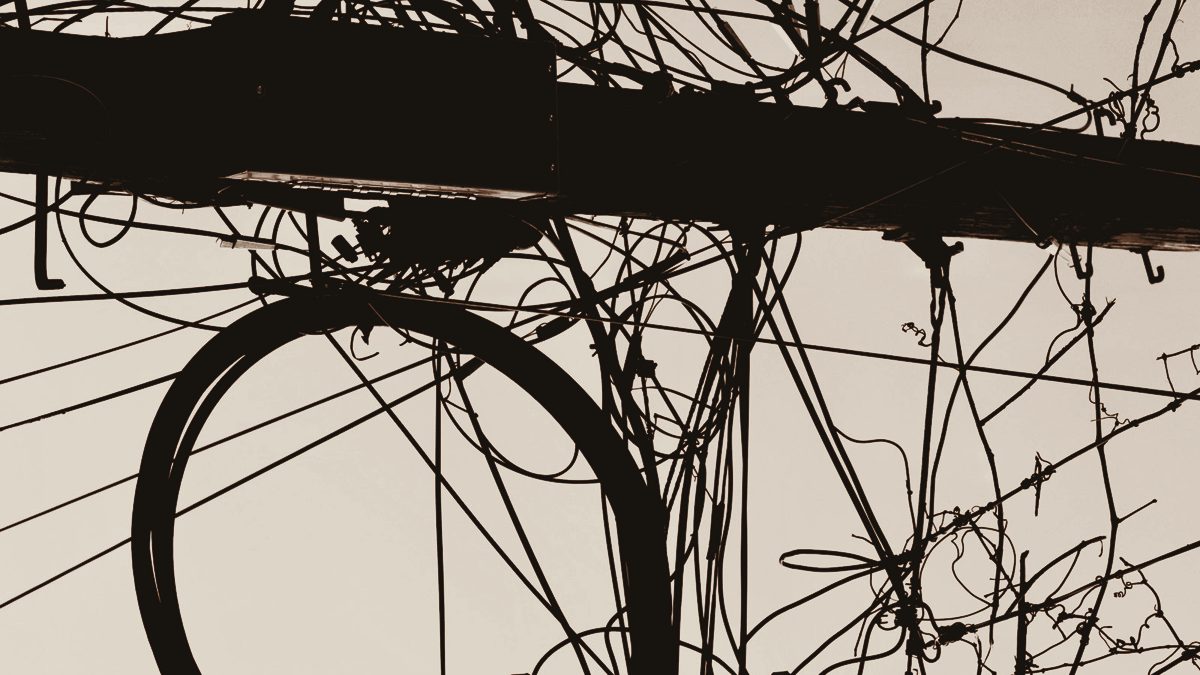 A dense tangle of overhead wires against the sky